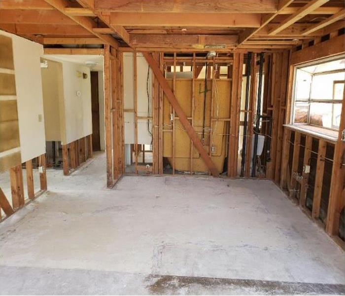 a open room with no drywall showing the framing of the kitchen. 