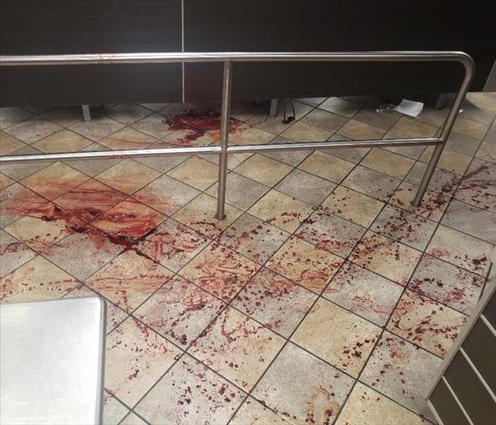 Restaurant tile floor is covered with splattered blood.